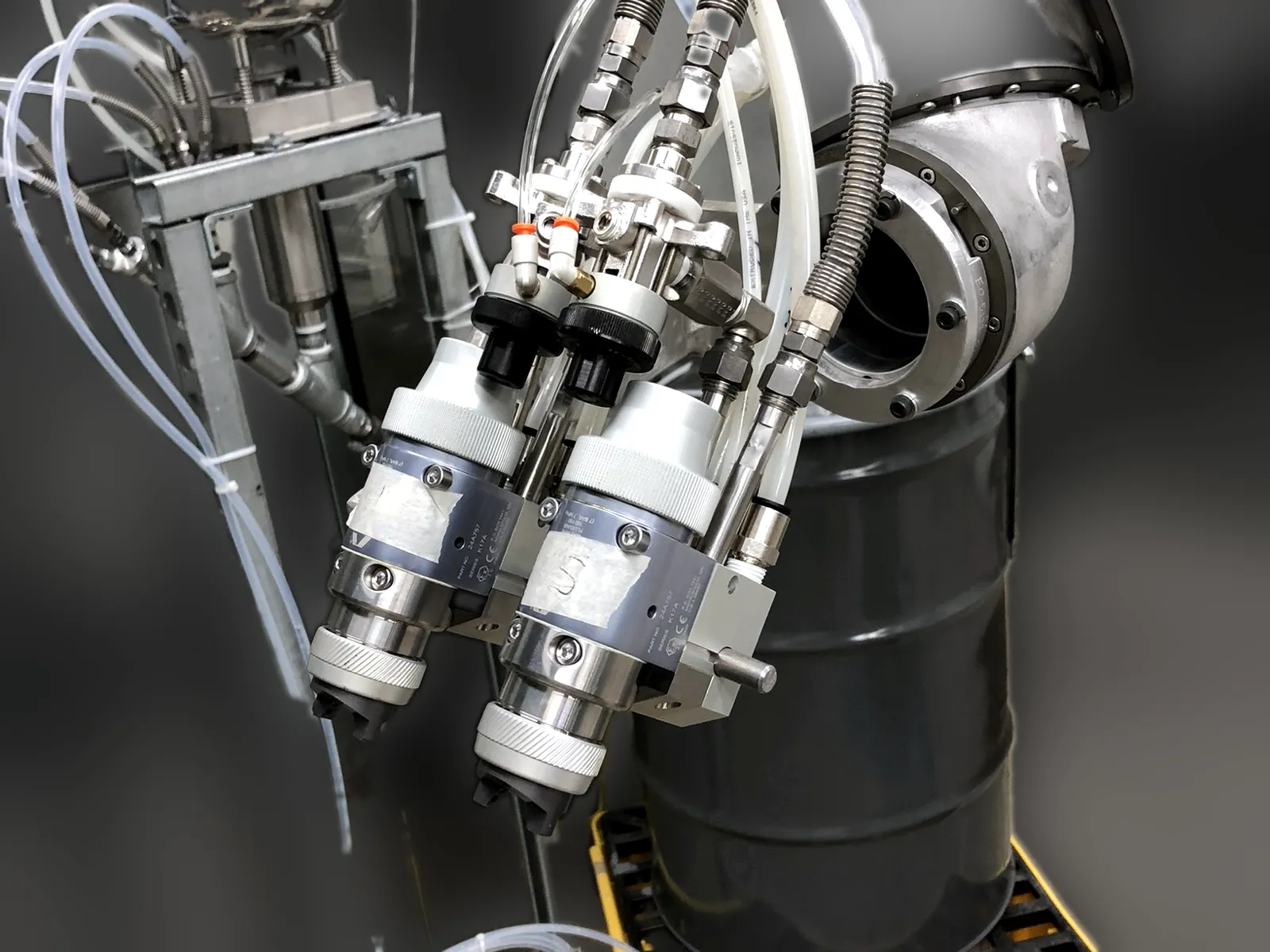 Dual head Graco automatic spray guns on a paint robot, installed by FTS